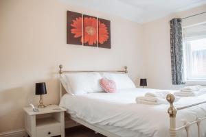 a bedroom with a white bed with two towels on it at Spacious Holiday Home with Free Parking in Harrogate