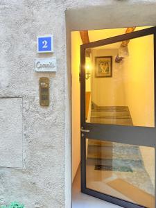 a door to a building with a sign that says at Gritti Palace Morcote - Camelia - Spacious historic house by the lake in Morcote