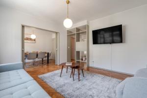 a living room with a couch and a table at HostWise - Bright & Spacious Flat w/ Garage in Porto