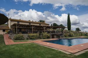 a house with a swimming pool in a yard at Terre di GIORGIO Agriturismo Villa la Palazzetta in Castiglione dʼOrcia