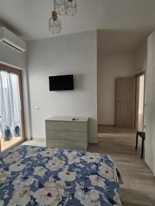 a bedroom with a bed and a tv on the wall at Casa LuMaré in Ponza