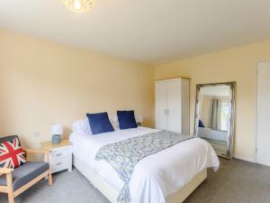 Un dormitorio con una cama, una silla y un espejo. en 3 Bed in Freshwater 79039, en Freshwater