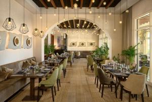 a dining room with long tables and chairs at The Chedi Luštica Bay in Tivat