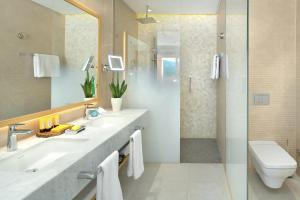 a bathroom with two sinks and a shower at The Chedi Luštica Bay in Tivat