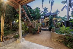 a resort with a staircase and palm trees at BonaVista Beach Hotel in Arugam Bay
