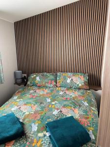 a bed with two pillows on it in a bedroom at J4 Lossiemouth Bay Caravan Park in Lossiemouth