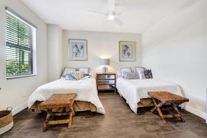 a bedroom with two beds and two chairs at Active Luxury Living with Golf Amenities in Bonita Springs +15 photos