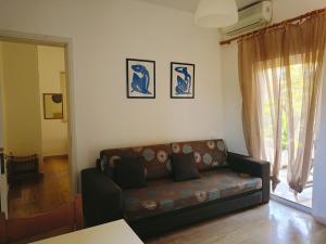 a living room with a couch and a window at Villa Fotis in Ligia