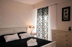 a bedroom with a bed with two towels on it at Sunset Penthouse Apartment with Jacuzzi and Seaview in Zadar