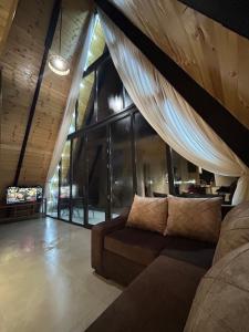 a living room with a couch and a large window at Sunshine Borjomi in Borjomi