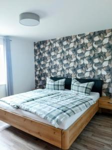 a bedroom with a bed with a wall with hats at Ferienwohnung Sauerland Fernblick in Olsberg