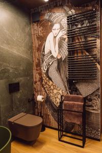 a bathroom with a painting of a mermaid on the wall at Sanatorium Dedal in Polańczyk