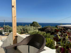 a wicker bench sitting on top of a wall at LEFKADA TWINS 2 in Agios Kirykos +6 photos
