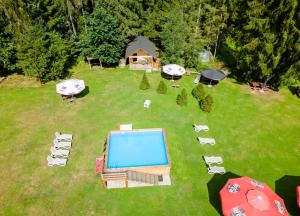 an aerial view of a backyard with a swimming pool at Olza Karczma i pokoje in Istebna +78 photos