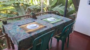 a table with two plates on top of it at Shanti Guest House Ella in Ella