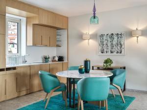 a kitchen and dining room with a table and chairs at The Chedi Luštica Bay in Tivat