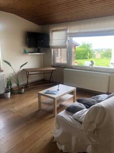 a room with a bed and a table and a window at Le Coeur sur la Main in Namur