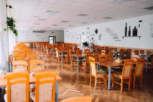 a dining room with wooden tables and chairs at Sanatorium Dedal in Polańczyk