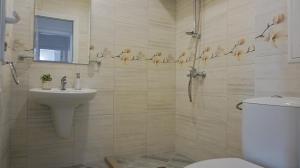 a bathroom with a toilet and a sink at Апартаменти Атеа на плажа - Apartments Atea on the beach in Obzor +36 photos