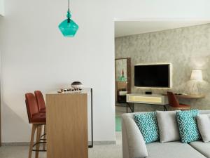 a living room with a couch and a tv at The Chedi Luštica Bay in Tivat