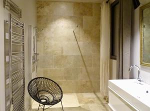 a bathroom with a shower with a chair in it at Maison du Lac in Les Angles Gard +63 photos