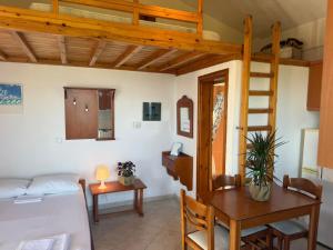 a room with a bed and a desk and a loft bed at LEFKADA TWINS 4 in Agios Kirykos