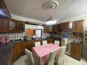 a kitchen with a table with a pink table cloth at Luxury Duplex In the center of Irbid -Spacious 4BR in Irbid