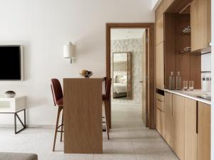 a kitchen with a table and chairs in a room at The Chedi Luštica Bay in Tivat