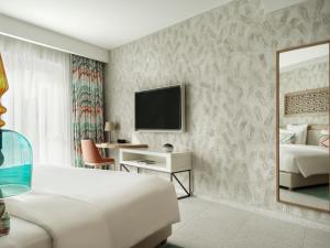 a hotel room with a bed and a mirror at The Chedi Luštica Bay in Tivat