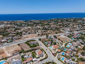 an aerial view of a city with houses and the ocean at H&O Villa Arizona Gold Residence in Peyia