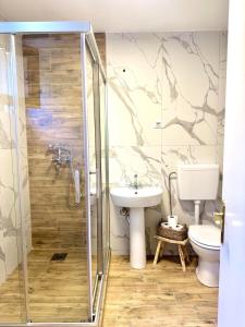 a bathroom with a shower and a toilet and a sink at The Secret Garden in Ljubaništa +10 photos