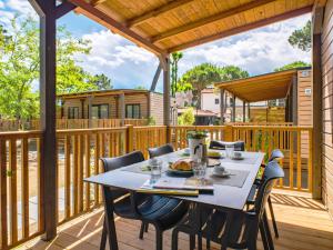 a patio with a table and chairs on a deck at Club del Sole Le Mimose Family Resort in Porto SantʼElpidio