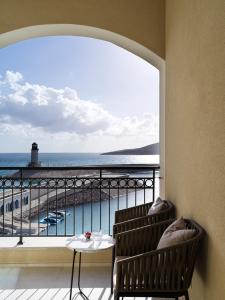 a balcony with a table and a view of the ocean at The Chedi Luštica Bay in Tivat