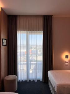 Postel nebo postele na pokoji v ubytování Hotel Delta Premium