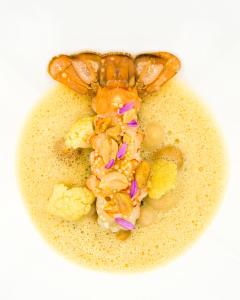 a crab is sitting on top of cauliflower at Hotel Atlantic Hamburg, Autograph Collection in Hamburg