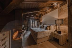 Rúm í herbergi á Ultima Hotel Gstaad