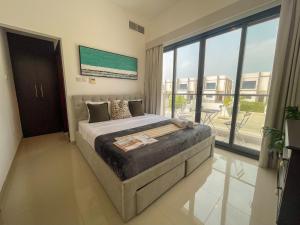 a bedroom with a large bed and a large window at Marina & Mountain View 4BR Private Villa in Fujairah +26 photos