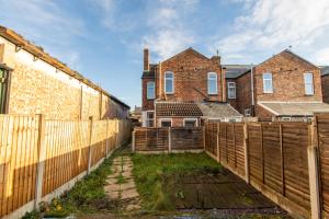 a wooden fence in front of a house at K Suites - Granville Avenue in Long Eaton