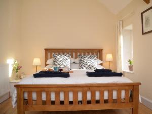 a bedroom with a large bed with two pillows at 2 bed property in Ilminster Somerset 56523 in Ilminster