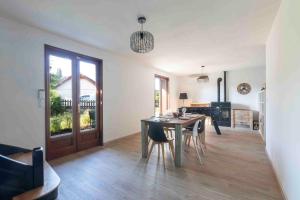 a kitchen and dining room with a table and chairs at Cabana & Pavillon Bressan - Garden, Parking in Pierre-de-Bresse