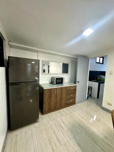 a kitchen with a stainless steel refrigerator in a room at Scarlett Rae Bungalow house with Lake View in Angeles