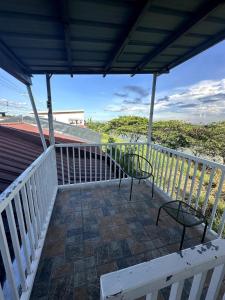 a balcony with chairs and a view of the ocean at Scarlett Rae Bungalow house with Lake View in Angeles +5 photos