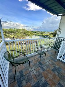 a balcony with chairs and a view of the water at Scarlett Rae Bungalow house with Lake View in Angeles