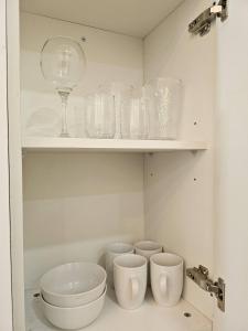 a cupboard filled with glasses and a wine glass at The Bellagio Luxury Inn in Breadnut Hill