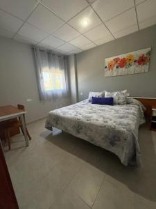 Un dormitorio con una cama con una almohada azul encima. en Apartment Autovia Bormujos, en Bormujos
