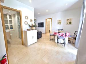 a living room with a table and chairs and a television at Charming Apartment in the Heart of Old Town in Marbella