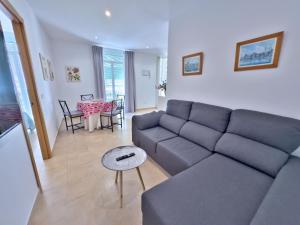 a living room with a couch and a table at Charming Apartment in the Heart of Old Town in Marbella
