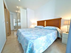 a bedroom with a bed with a blue comforter at Charming Apartment in the Heart of Old Town in Marbella