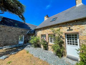 an old stone house with a white garage at Ty Gwen, La Belle Pierrette Bretonne in Plouha +30 photos