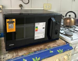 a microwave oven sitting on top of a kitchen counter at Depto Centro in San Luis